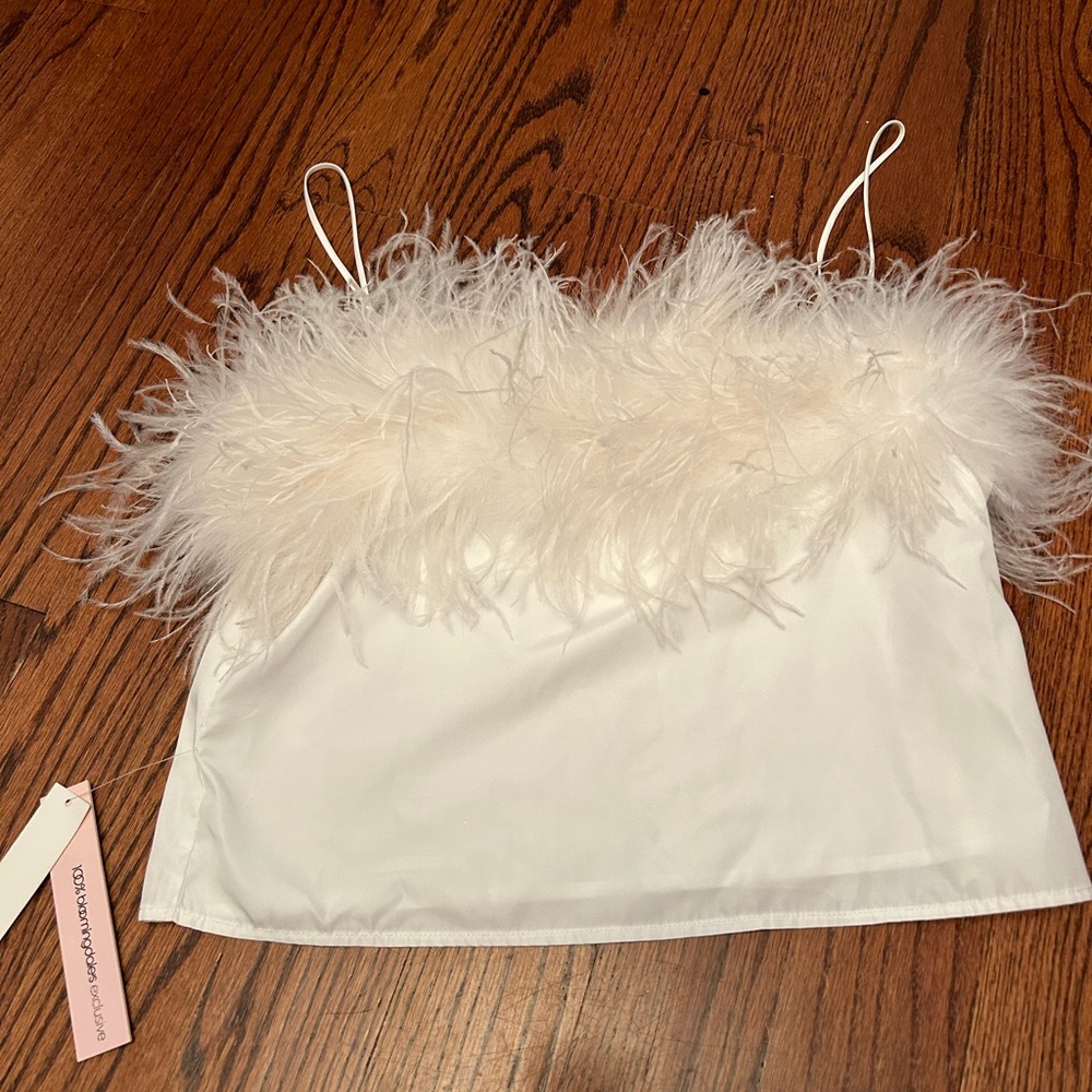 Bloomingdale’s aqua brand white top with feathers. New with tags on Never worn.